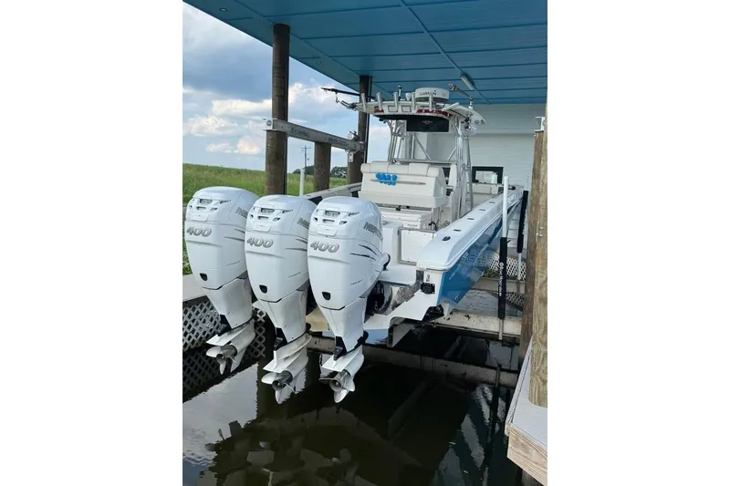 The Image of 2012 Fountain 38 Center Console boat with triple 2020 Mercury 400 engines on trailer. - 0