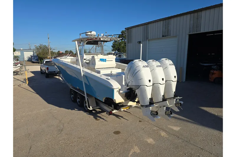 Slide: The Image of 2012 Fountain 38 Center Console boat with triple 400 horsepower engines on a trailer. - 13