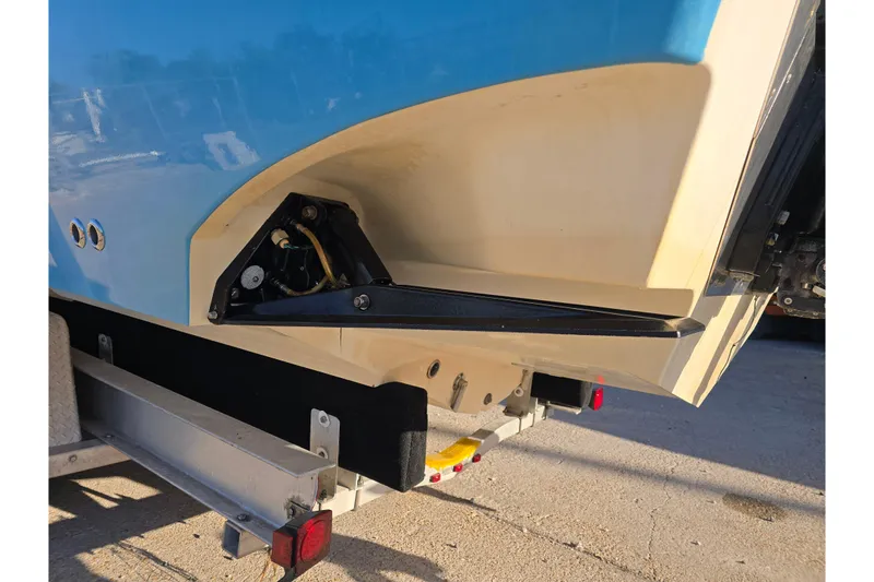 Slide: The Image of 2012 Fountain 38 Center Console boat on trailer, showing rear hull and trim tab. - 17