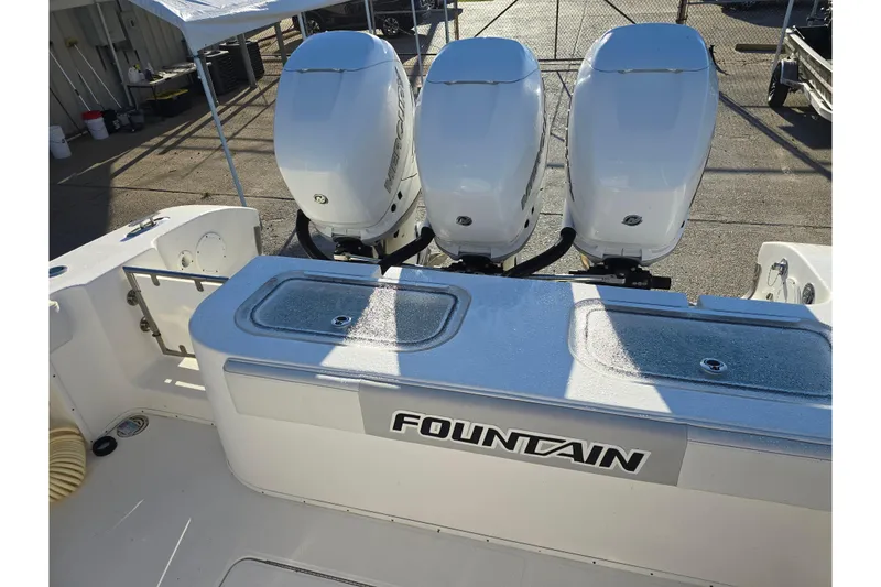 Slide: The Image of 2012 Fountain 38 Center Console boat with triple outboard engines. - 20