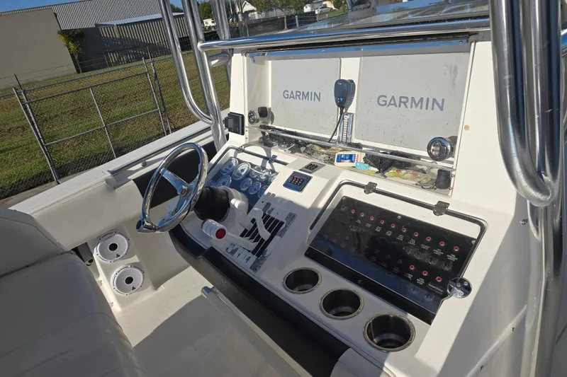 Slide: The Image of 2012 Fountain 38 Center Console boat dashboard with Garmin navigation systems. - 25