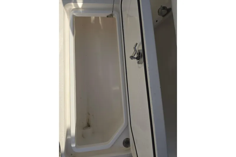 Slide: The Image of Open storage compartment on a 2012 Fountain 38 Center Console boat. - 28