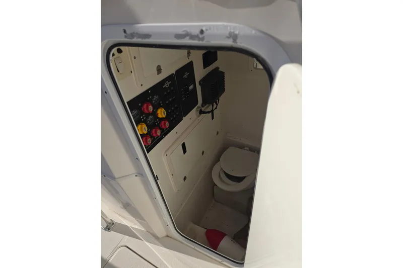 Slide: The Image of Interior of 2012 Fountain 38 Center Console boat with control panel and toilet. - 29