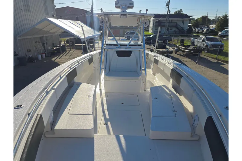 Slide: The Image of 2012 Fountain 38 Center Console boat with spacious deck and seating, docked outdoors. - 33