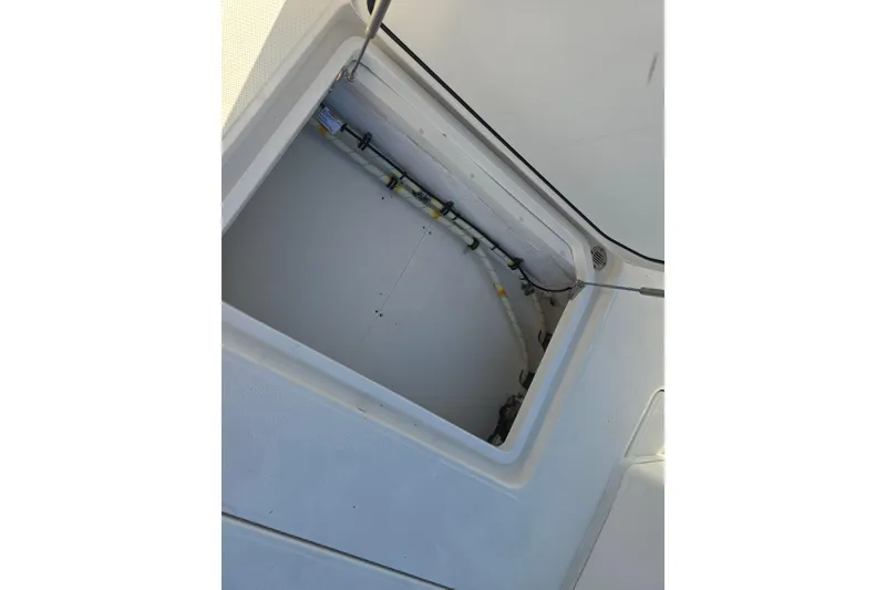 Slide: The Image of Open storage compartment on a 2012 Fountain 38 Center Console boat. - 38