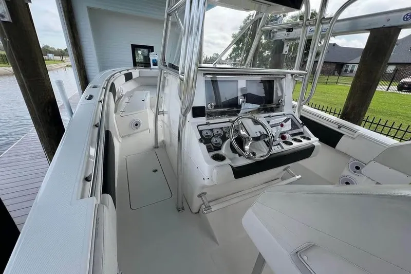 Slide: The Image of 2012 Fountain 38 Center Console boat interior with steering wheel and control panel. - 44