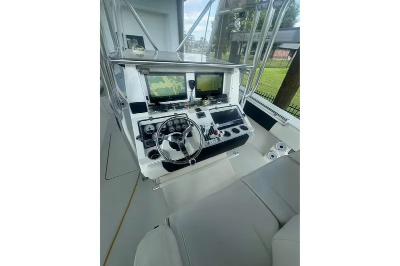 Slide: The Image of 2012 Fountain 38 Center Console boat docked by a canal, sunny day. - 6