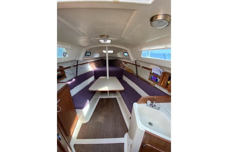 Slide: The Image of Interior of a 1990 Hunter 27 sailboat with seating and table. - 16
