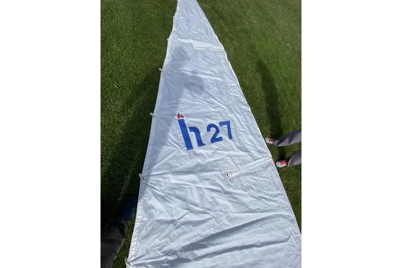 Slide: The Image of Sail of a 1990 Hunter 27 yacht laid out on grass. - 22