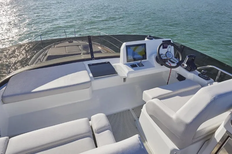 Slide: The Image of Flybridge of 2026 Beneteau Antares 12 Fly OB, featuring modern helm and seating. - 6