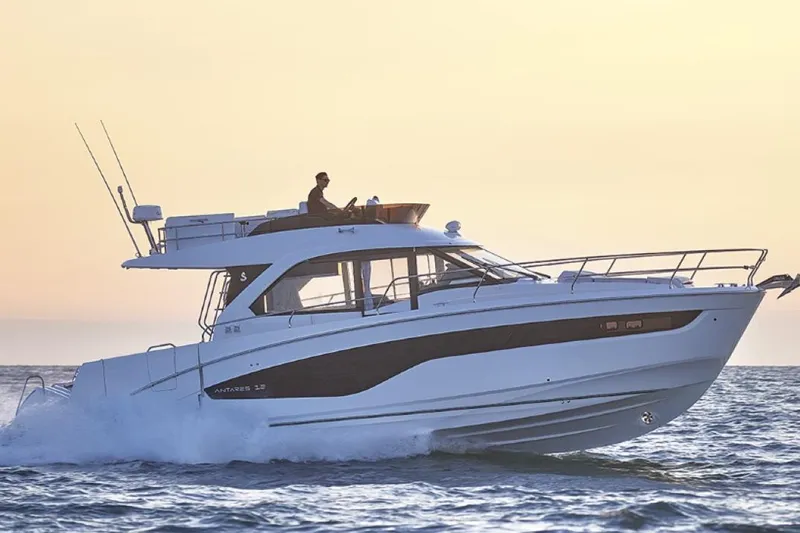 Slide: The Image of 2026 Beneteau Antares 12 Fly OB cruising on the ocean at sunset. - 8