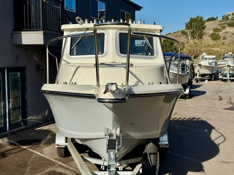 Slide: The Image of 2025 Defiance Admiral 220 EX boat on trailer, parked outdoors. - 11