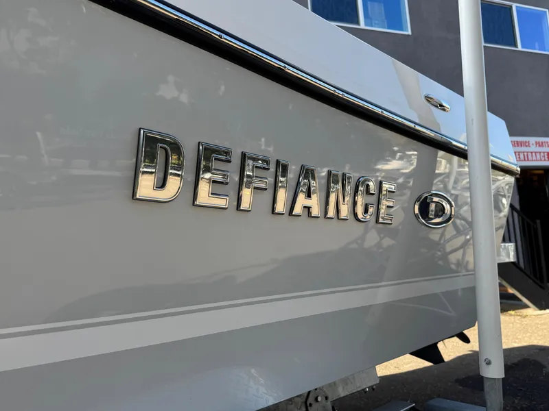 Slide: The Image of 2025 Defiance Admiral 220 EX boat with chrome lettering on the hull. - 13