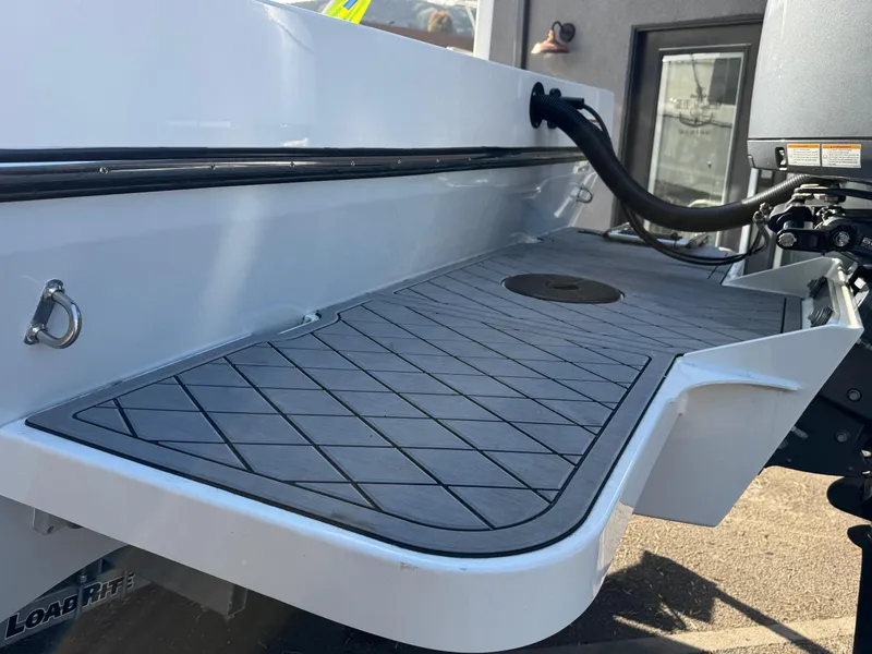 Slide: The Image of 2025 Defiance Admiral 220 EX boat deck with non-slip surface and motor mount. - 17