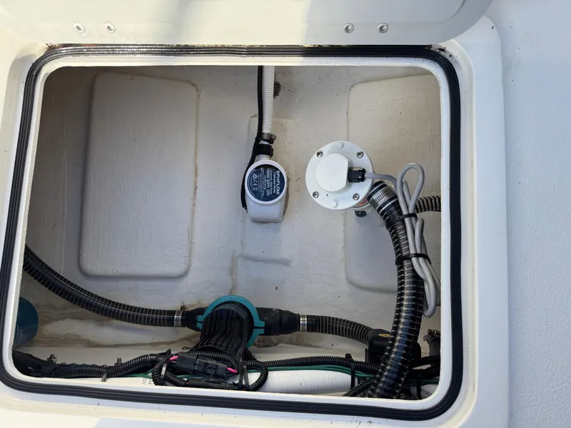 Slide: The Image of 2025 Defiance Admiral 220 EX boat compartment with wiring and pump system. - 22