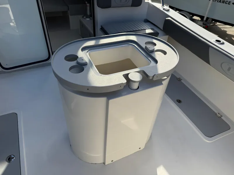 Slide: The Image of 2025 Defiance Admiral 220 EX boat interior with center console and cup holders. - 28