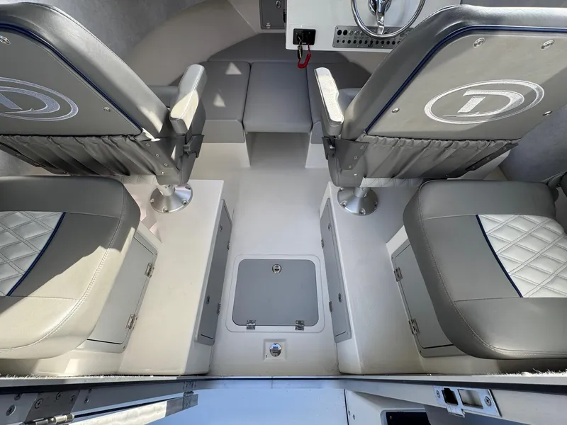 Slide: The Image of 2025 Defiance Admiral 220 EX interior with cushioned seating and storage compartments. - 33