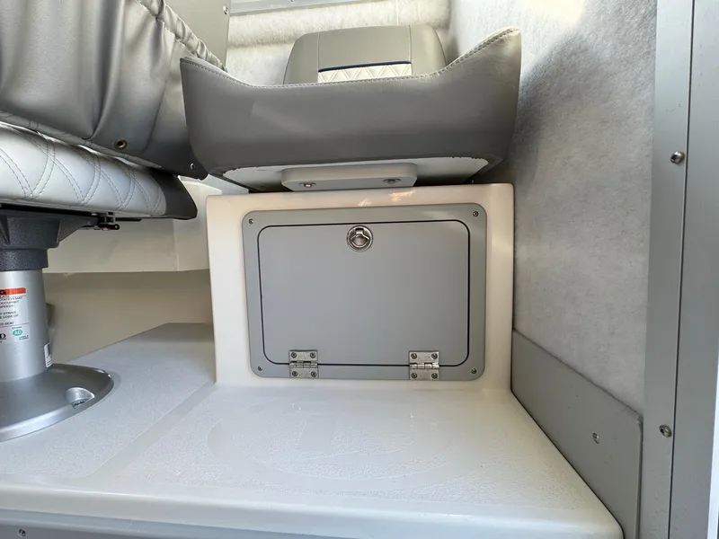 Slide: The Image of Interior of 2025 Defiance Admiral 220 EX boat, featuring a storage compartment and seating. - 34