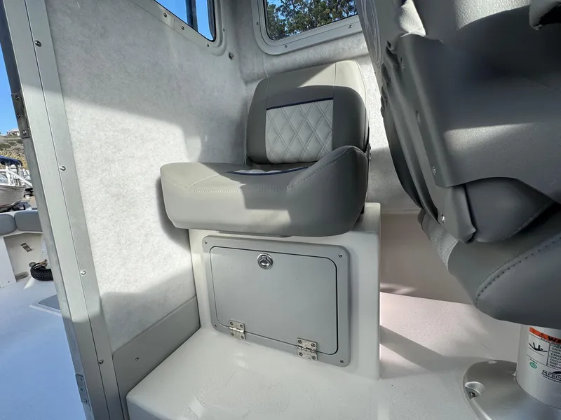 Slide: The Image of Interior seating of 2025 Defiance Admiral 220 EX boat, featuring cushioned seats and storage compartment. - 39