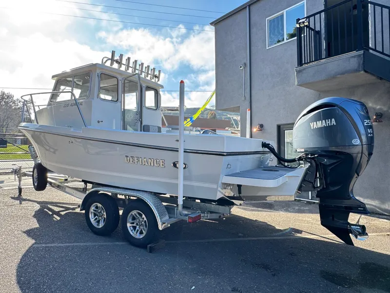 Slide: The Image of 2025 Defiance Admiral 220 EX boat on trailer with Yamaha outboard motor. - 4