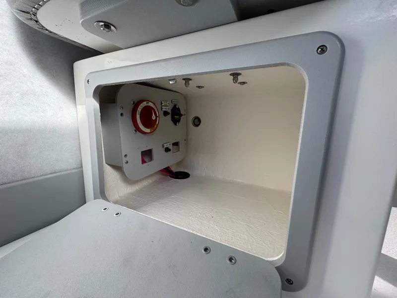 Slide: The Image of Storage compartment with control panel in 2025 Defiance Admiral 220 EX boat. - 40