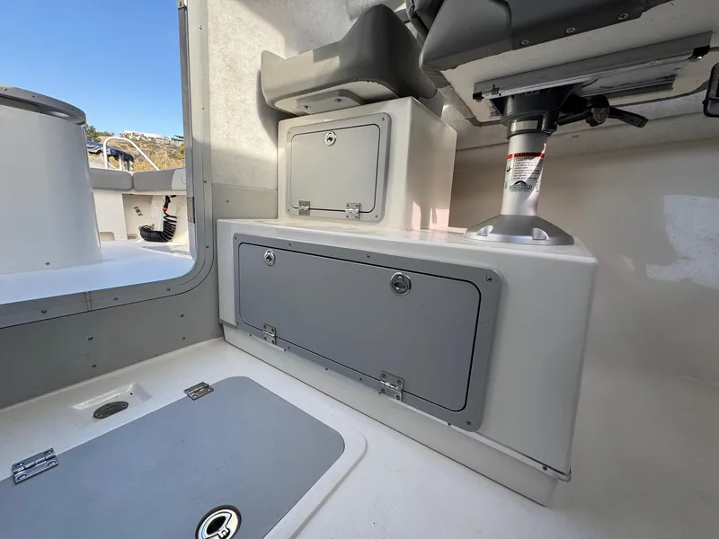 Slide: The Image of Interior of 2025 Defiance Admiral 220 EX boat, featuring storage compartments and seating. - 41