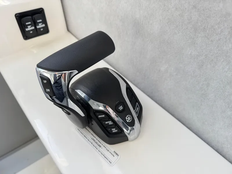 Slide: The Image of Throttle control lever on a 2025 Defiance Admiral 220 EX boat. - 46
