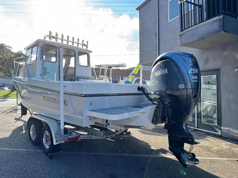 Slide: The Image of 2025 Defiance Admiral 220 EX boat with Yamaha 250 V6 engine on trailer. - 5