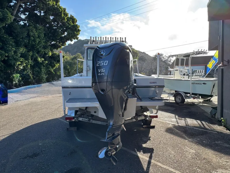 Slide: The Image of 2025 Defiance Admiral 220 EX boat with powerful 250 V6 engine, parked outdoors. - 6