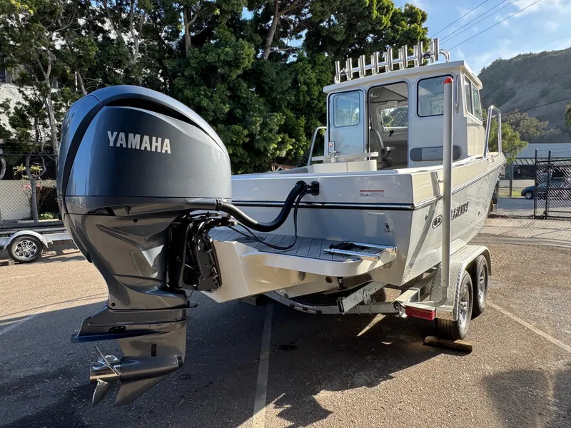 Slide: The Image of 2025 Defiance Admiral 220 EX boat with Yamaha outboard motor on a trailer. - 7