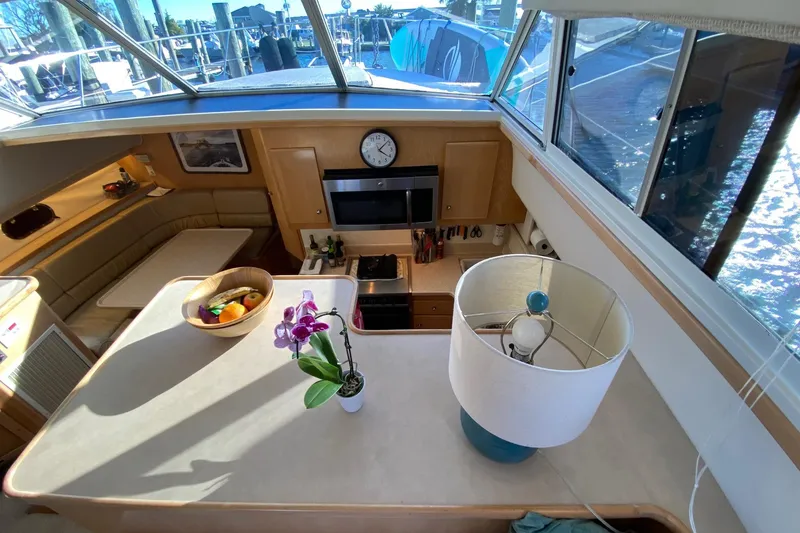 Slide: The Image of Interior of 1998 Carver 445 Aft Cabin Motor Yacht with kitchen and seating area. - 23