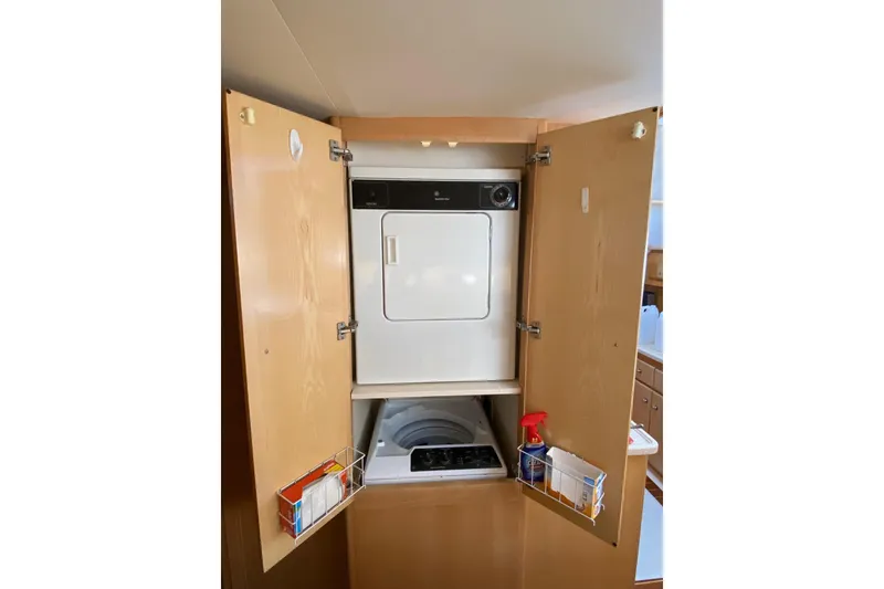 Slide: The Image of Laundry area inside 1998 Carver 445 Aft Cabin Motor Yacht with washer and dryer. - 28