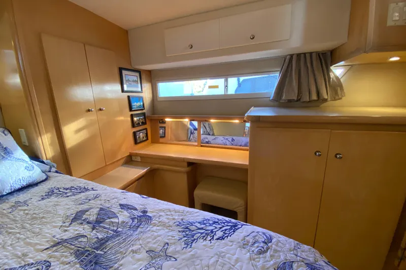 Slide: The Image of 1998 Carver 445 Aft Cabin Motor Yacht interior with cozy bedroom and nautical decor. - 32