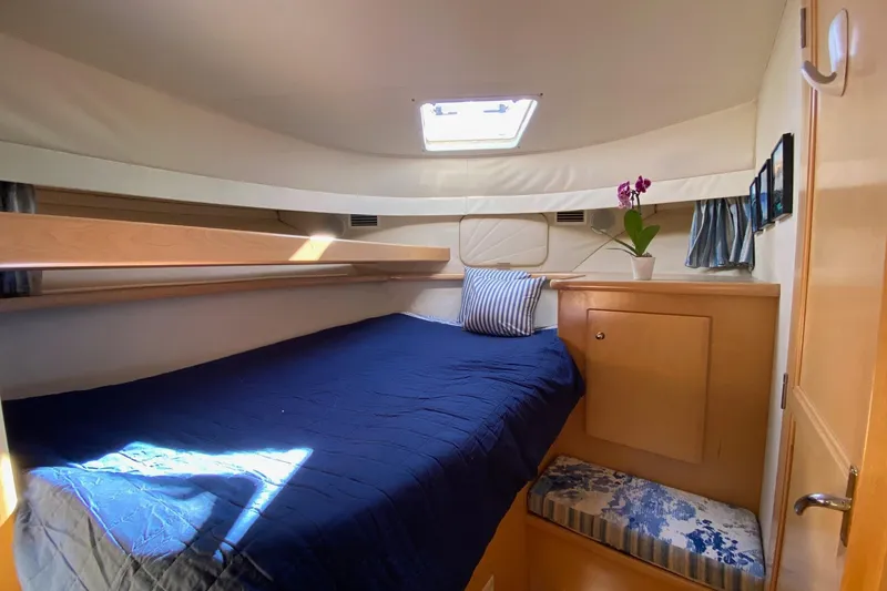 Slide: The Image of Cozy cabin interior of 1998 Carver 445 Aft Cabin Motor Yacht with bed and porthole. - 38