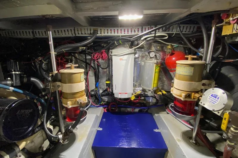 Slide: The Image of Engine room of 1998 Carver 445 Aft Cabin Motor Yacht, showcasing mechanical components. - 44