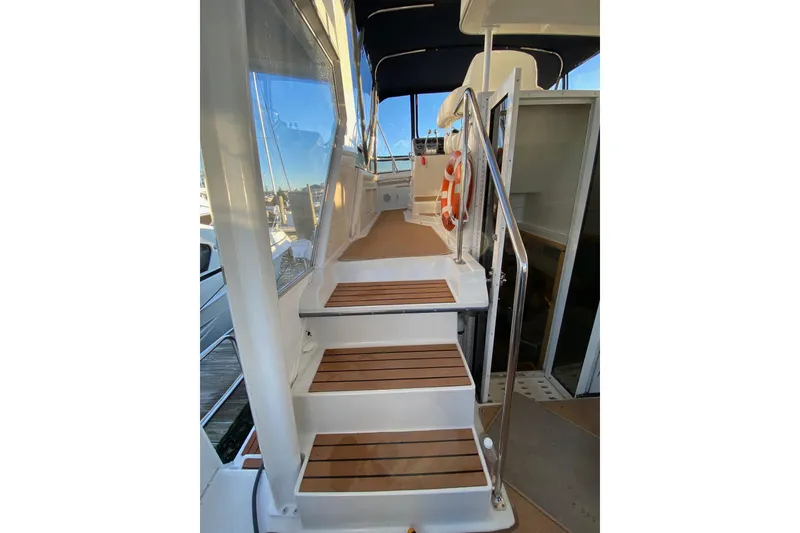 Slide: The Image of Staircase on 1998 Carver 445 Aft Cabin Motor Yacht with wooden steps and railing. - 11
