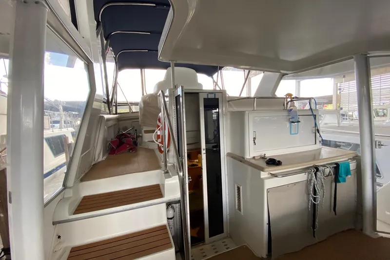 Slide: The Image of 1998 Carver 445 Aft Cabin Motor Yacht interior with stairs and kitchenette. - 12
