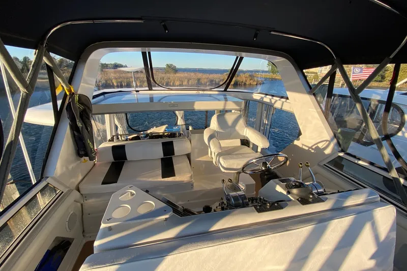 Slide: The Image of 1998 Carver 445 Aft Cabin Motor Yacht interior with helm and seating area. - 16