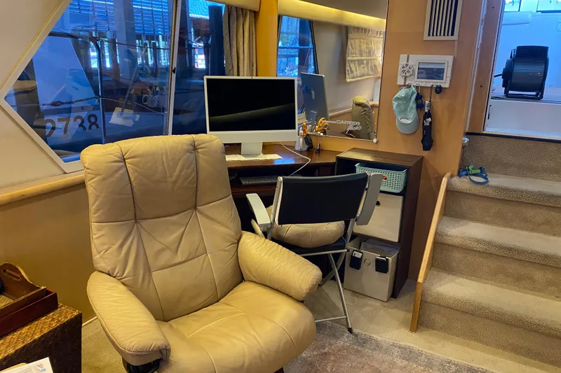 Slide: The Image of Interior of 1998 Carver 445 Aft Cabin Motor Yacht with office setup and seating. - 21