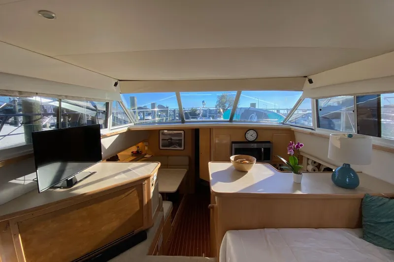 Slide: The Image of Interior of 1998 Carver 445 Aft Cabin Motor Yacht with modern amenities and panoramic windows. - 22