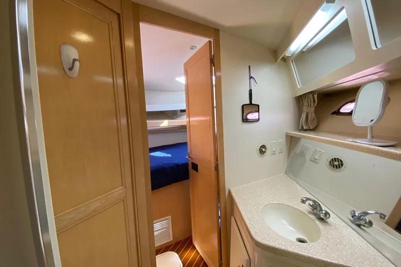 Slide: The Image of Interior of 1998 Carver 445 Aft Cabin Motor Yacht with sink and bedroom view. - 39