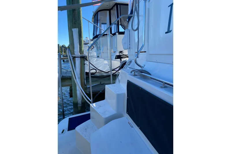 Slide: The Image of 1998 Carver 445 Aft Cabin Motor Yacht docked, featuring steps and railing. - 4