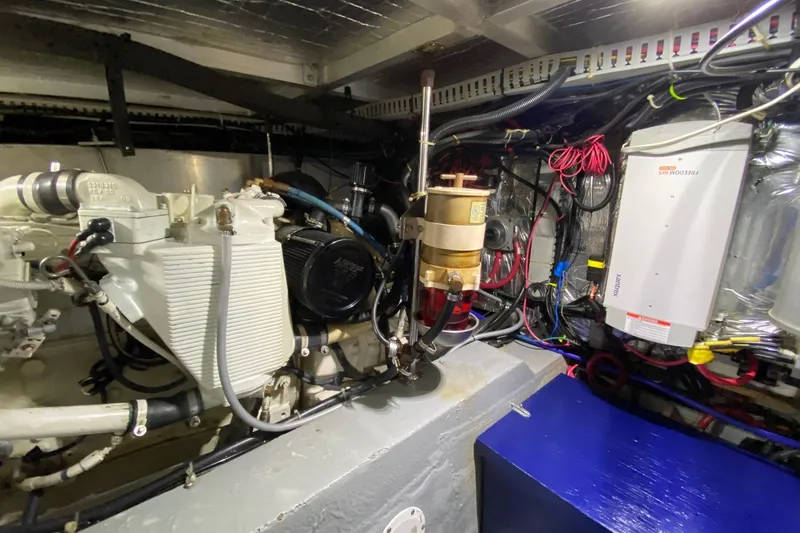 Slide: The Image of Engine room of 1998 Carver 445 Aft Cabin Motor Yacht with visible machinery and wiring. - 43
