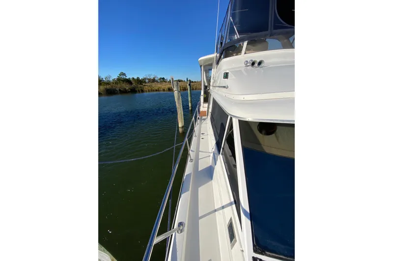 Slide: The Image of 1998 Carver 445 Aft Cabin Motor Yacht docked on a sunny day. - 8