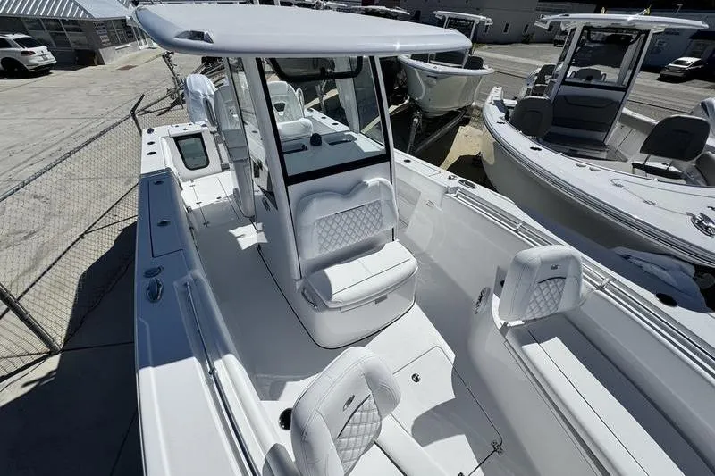 Slide: The Image of 2026 Sportsman Open 262 Center Console boat with sleek white interior and seating. - 11
