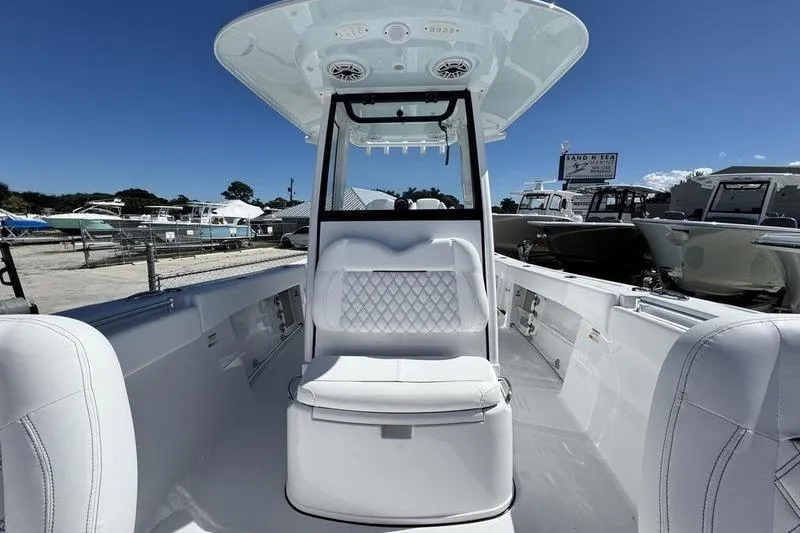 Slide: The Image of 2026 Sportsman Open 262 Center Console boat interior with white seating and console. - 12