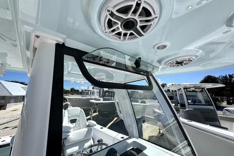 Slide: The Image of 2026 Sportsman Open 262 Center Console boat interior with speakers and windshield. - 13