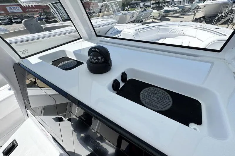 Slide: The Image of 2026 Sportsman Open 262 Center Console dashboard with compass and controls. - 17