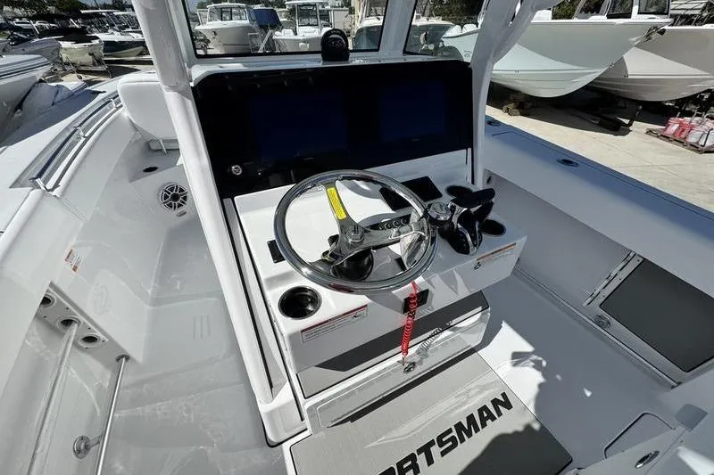 Slide: The Image of 2026 Sportsman Open 262 Center Console boat interior with steering wheel and controls. - 19