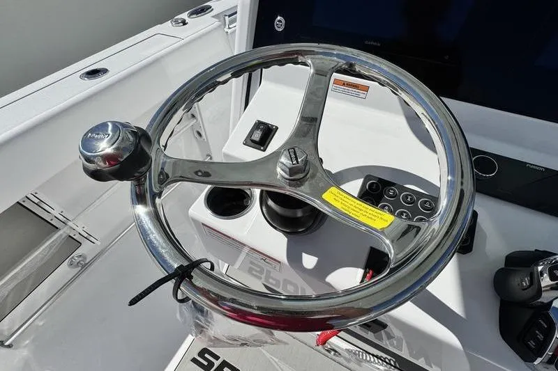 Slide: The Image of Steering wheel of 2026 Sportsman Open 262 Center Console boat, featuring modern controls. - 21